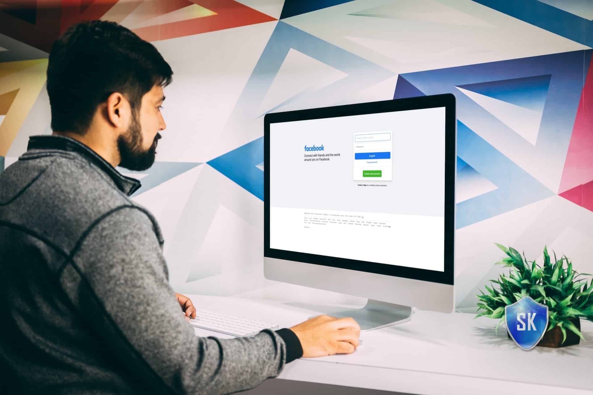 man on mac visiting facebook